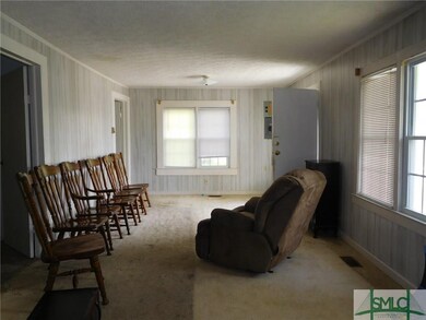 Large living room. There are two bedrooms to rear 