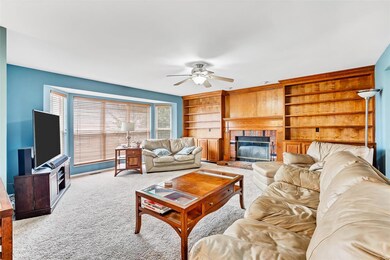Family room with build in book cases and bay windo