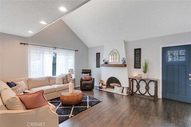 Another shot of the living room and beautiful floors and front door