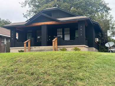 View of front of home featuring covered porch and a front lawn