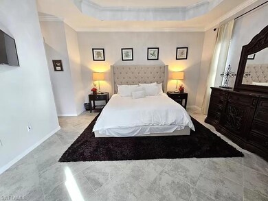 Bedroom featuring ornamental molding and a raised ceiling