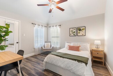 This secondary bedroom has a walk-in closet and two windows that let in lots of natural light.