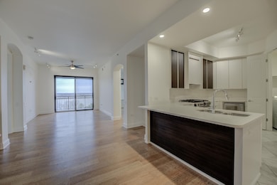 Kitchen featuring a sink, light countertops, baseb