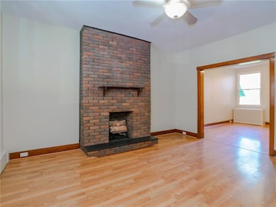 Front door opens into living room with sleek lamin