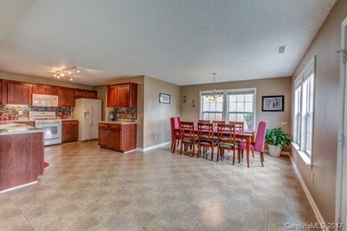 Open kitchen with large dining room with seating f