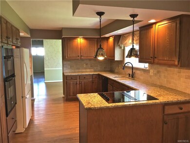 Updated kitchen features granite, new backsplash, 