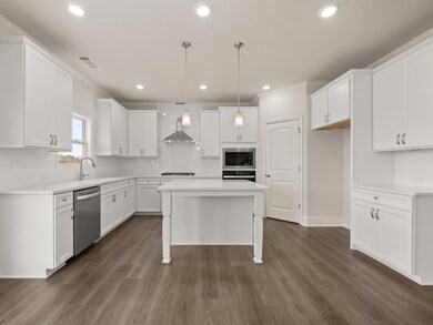 Grayson kitchen with dark harwood flooring and whi