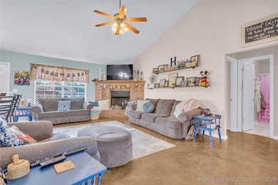 Living room with ceiling fan, a brick fireplace, c