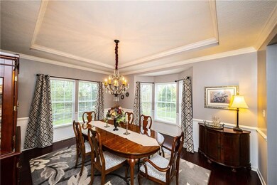 Elegant dining room with trey ceilings, hardwood f