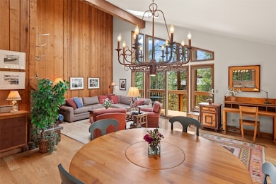 Dining space with wood finished floors, wood walls