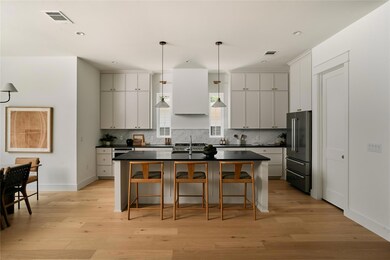 Kitchen featuring high end fridge, dark counterto