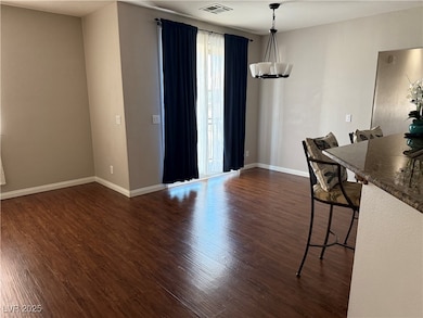 Dining area featuring dark wood-type flooring and