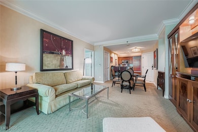 Living room featuring ornamental molding and baseboards