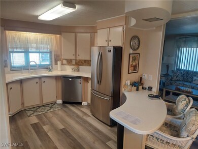 Kitchen featuring sink, a textured ceiling, stainl
