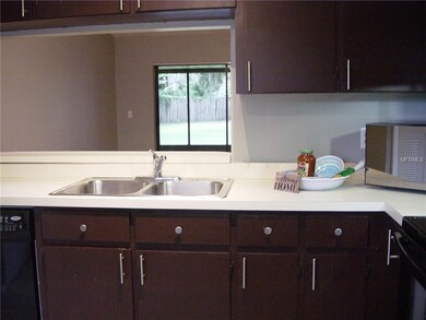 Kitchen overlooks living/dining area with open cou