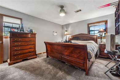 807 Charleston - Bedroom featuring light carpet, baseboards, and a ceiling fan
