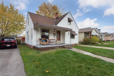 Bungalow with a front lawn and covered porch