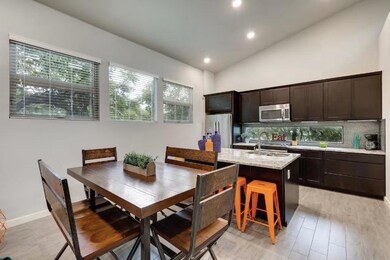 Kitchen with stainless steel appliances, an islan