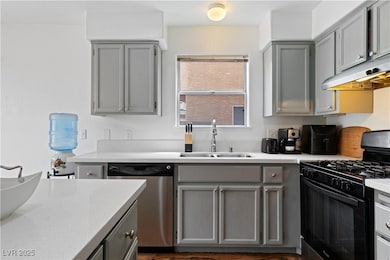 Kitchen featuring gray cabinets, light countertops