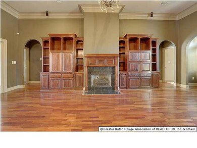 Huge living room with built-ins, fireplace, tall ceilings with stacked mouldings, screened porch to the left, master suite to the left, two bedrooms and full bath to the right. Hard wood floors. Beautiful!
