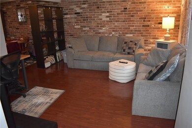 Living Room with real brick accent wall