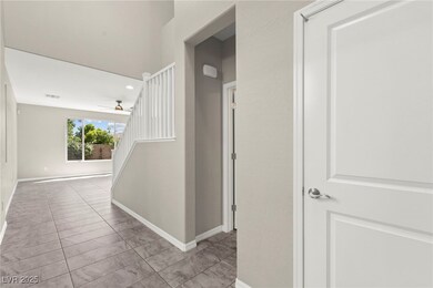 Corridor with baseboards, tile patterned flooring,
