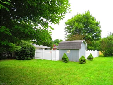 View from the SW corner showing rear of home, shed