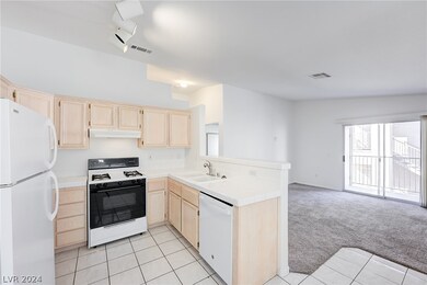 KITCHEN WITH VIEW OF LIVING ROOM