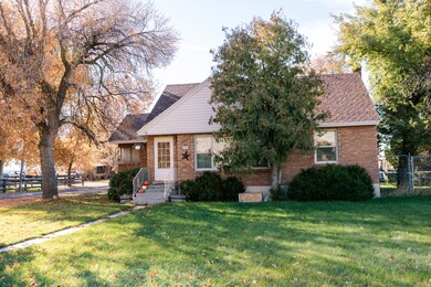 View of front of house with brick siding and roof with shingles