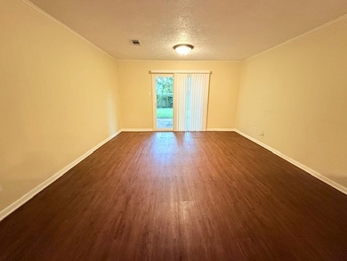 Empty room with dark wood-style floors, ornamental