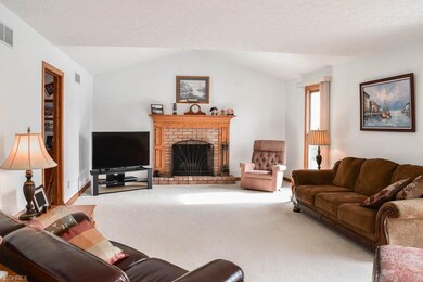 The great room has a fireplace with an oak mantle.