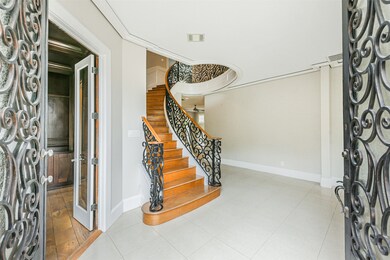 Enter through double doors to soaring ceilings and