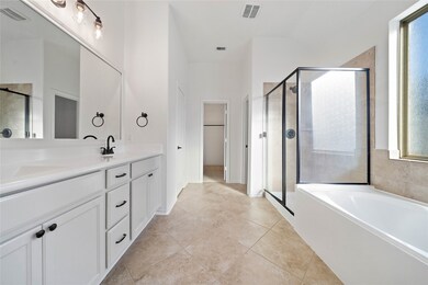 The spa-like primary bath is enormous with a new frameless shower.