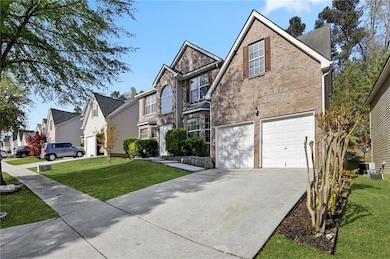 Traditional home with driveway, brick siding, an attached garage, a front lawn, and a residential view