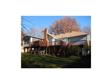 Full view of back of home. Doors to garage and mas