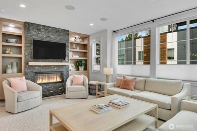 Numerous custom built ins and recessed dimmable lighting flank your rock-faced fireplace.