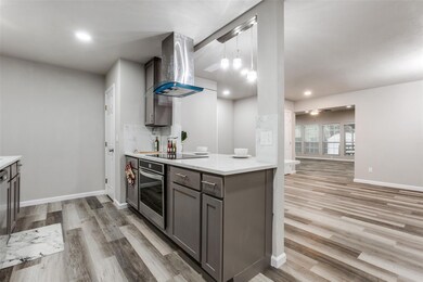 Kitchen with oven, wall chimney range hood, light 