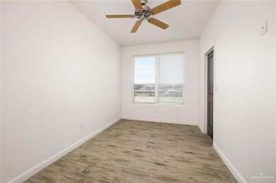 Unfurnished room with light wood-style flooring and ceiling fan