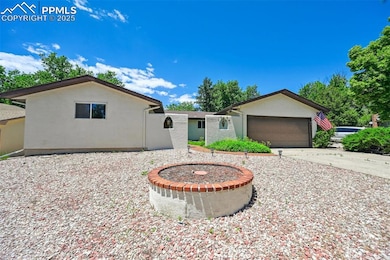 View of front facade with an attached garage, concrete driveway, and stucco siding
