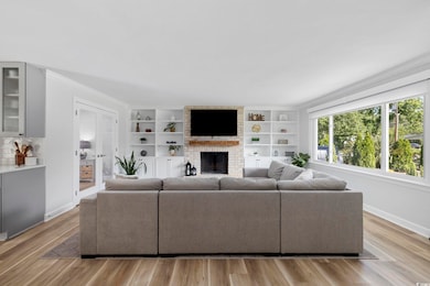 Living room with baseboards, ornamental molding, a