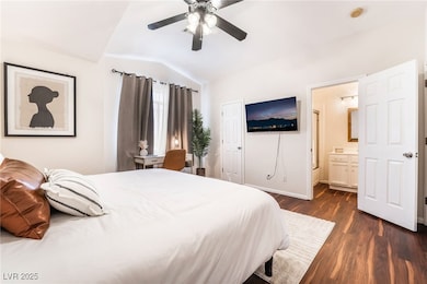 Bedroom with baseboards, ceiling fan, dark wood-st