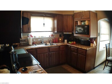 Efficient eat in kitchen with Hickory Cabinets and