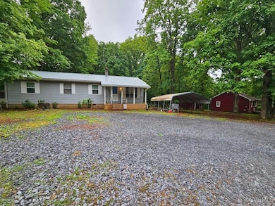Ranch-style house with a detached carport, drivewa