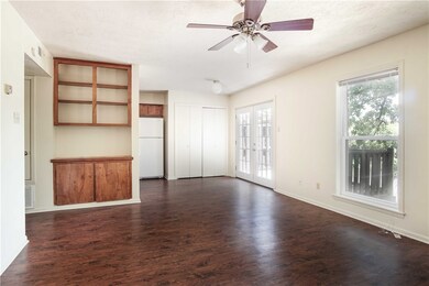 Unfurnished living room featuring dark wood-type f