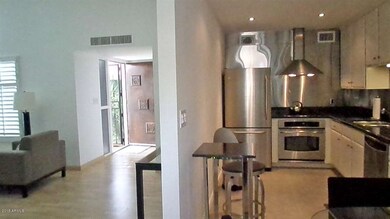 View of entrance and kitchen from dining