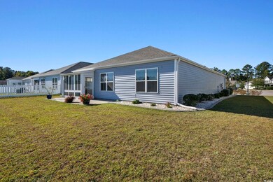Rear view of house with a lawn