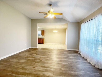 View of Living Room with Kitchen and Dining area in the background.