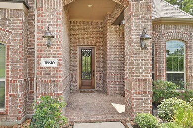 WELCOMING ENTRY:  Details matter, and the brick flooring on the entry porch, coupled with the mahogany door with iron work, are the details that you can expect in a home built by well respected Village builders.  Coach lights flank either side of the front porch and a recessed light illuminates the handsome front door after dark.