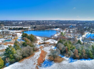 Snowy aerial view with a water view