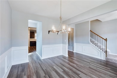 Unfurnished dining area featuring a chandelier and